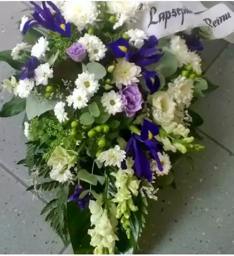 Funeral arrangement of white and purple flowers