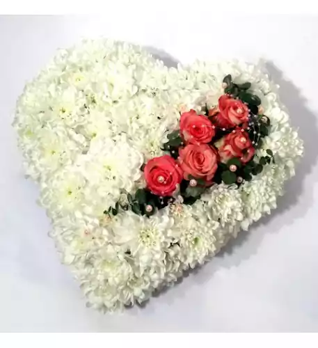 White heart-shaped arrangement of chrysantemums