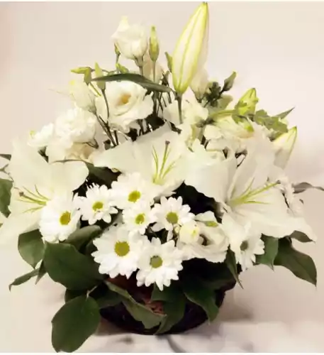 Basket arrangement of white blooms: Lilys, Roses, Chrysantemums