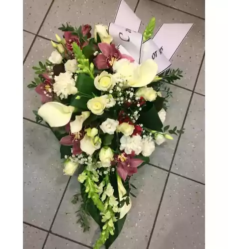 Funeral arrangements: dark orchids, white roses, lisianthus and callas
